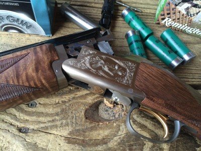 Both sides of the alloy receiver are engraved with upland hunting scenes. 