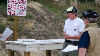 Local Match Director, Chuck Limpert gives new shooters a safety and rules orientation. Note that there is a designated area for safe firearm handling.