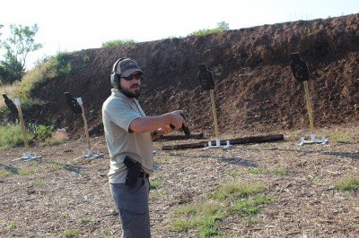 Thunderbird Tactical instructor and GunsAmerica writer Daniel Shaw demonstrating how to brace the hammer on the way back to the holster.