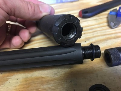 The barrel is threaded 1/2x28, but with a full length cut like a standard AR-15.