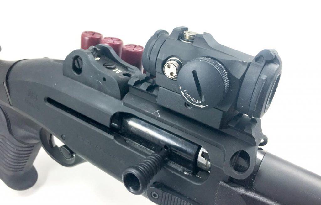 The Aimpoint Micro H-2 is attached with a quick-detach mount, so if it pukes the iron ghost ring sights are there and ready. 