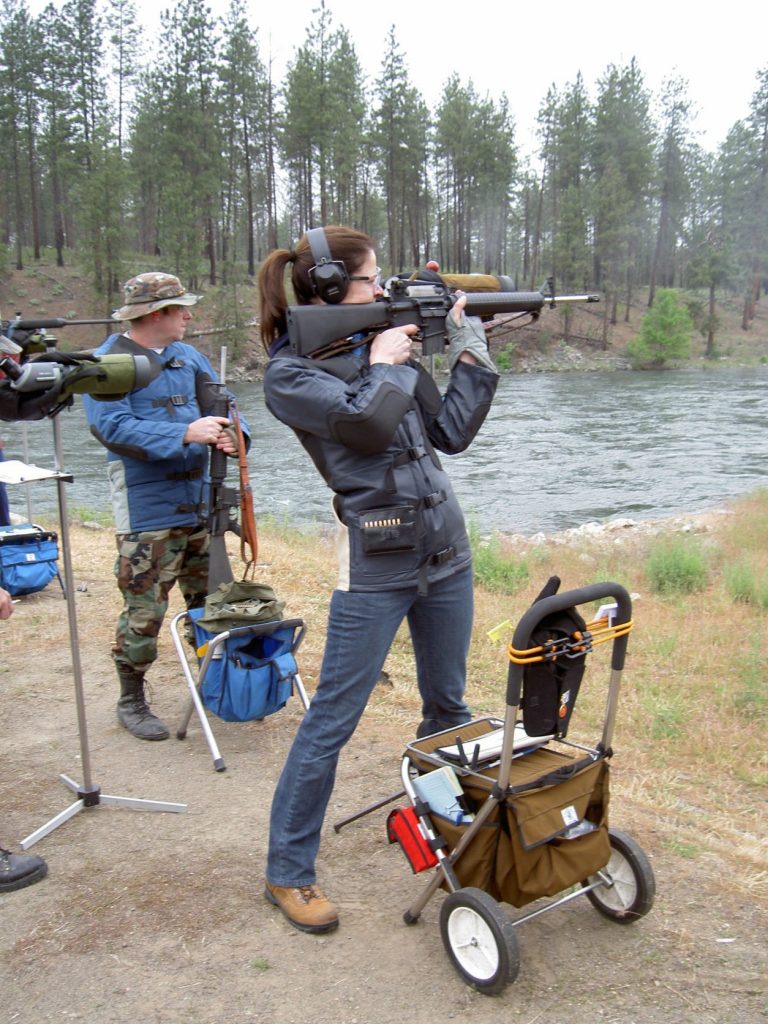 Anette Wachter, shooting standing Service Rifle. Note her left arm against her body, and her hand on the rifle under the sling, in front of the magazine.