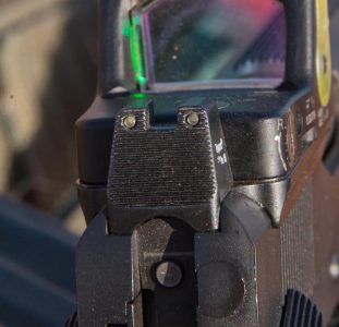 The rear sight is a tritium-equipped, suppressor-height unit.