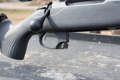 The aluminum bottom metal has an enlarged trigger guard for use with gloves.