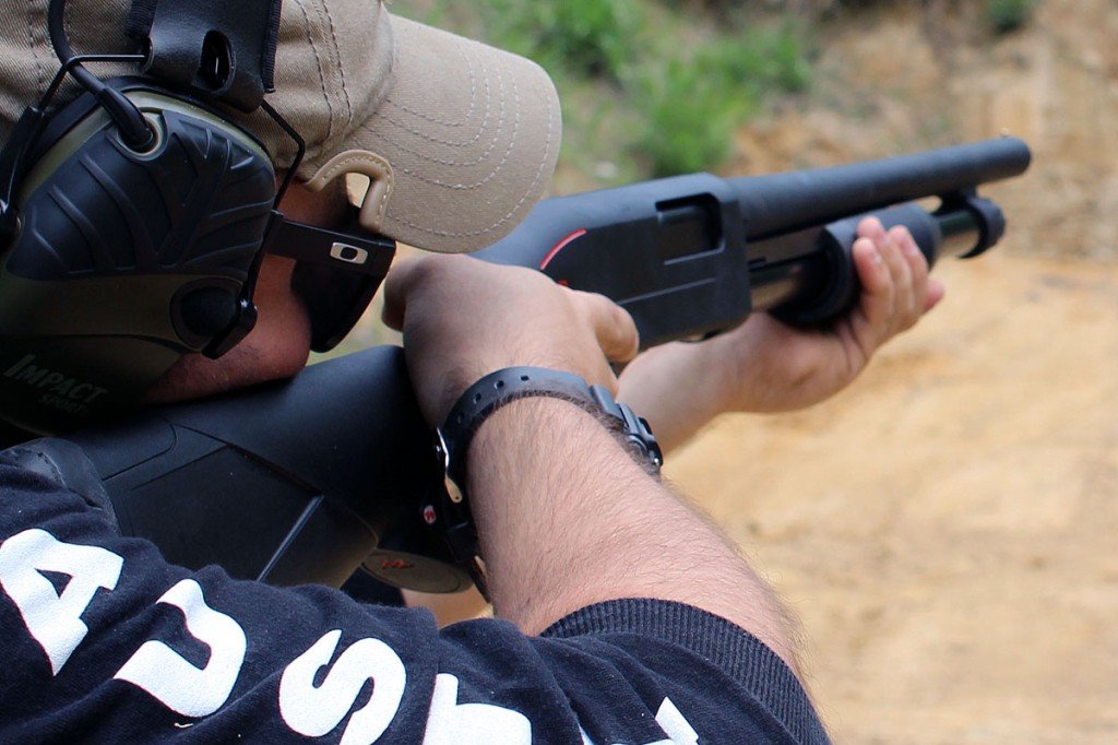 Man with eye and ear protection shooting Winchester SXP shotgun