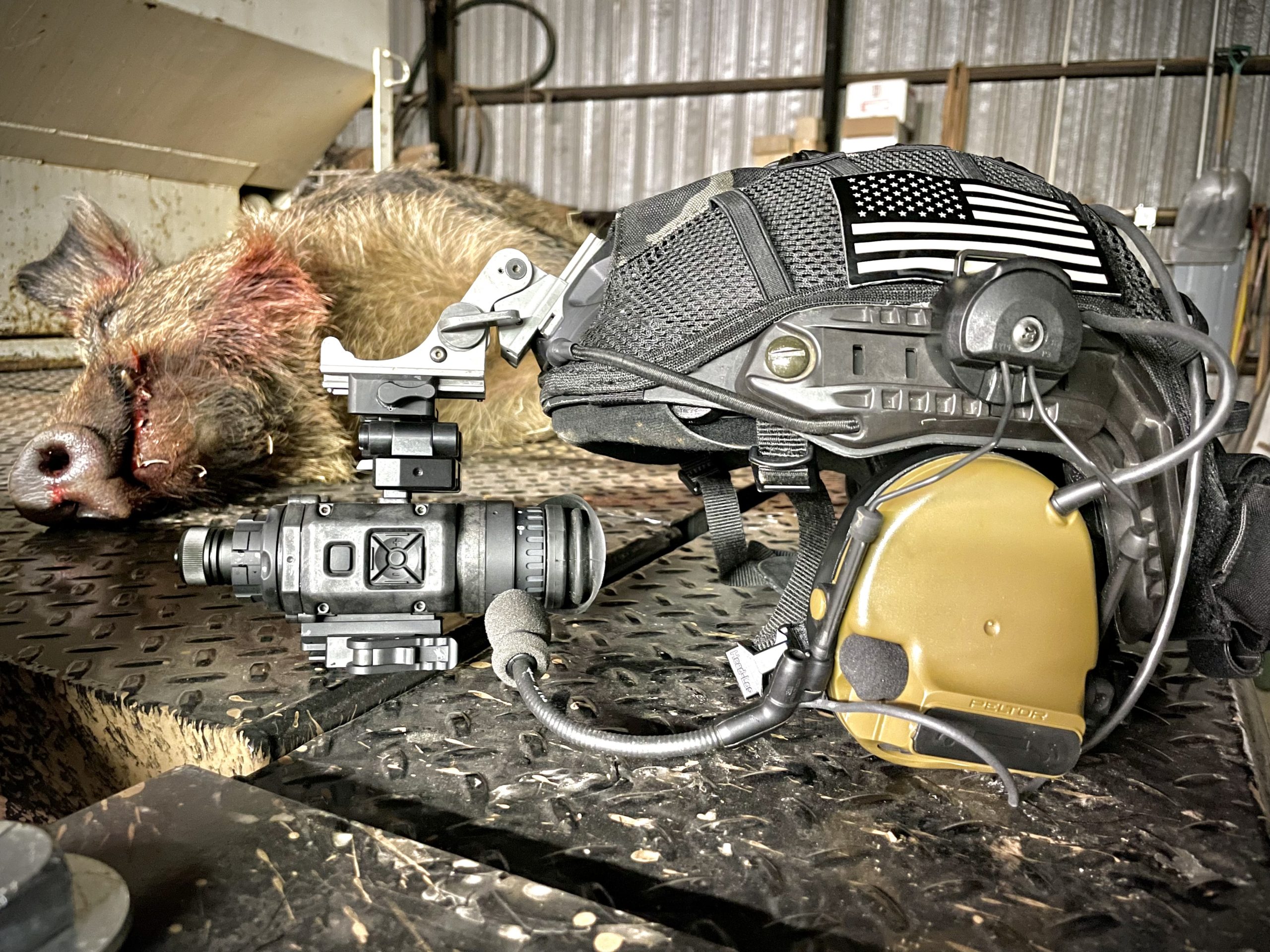 N-Vision NOX18 thermal monocular on a helmet next to a hog taken at night