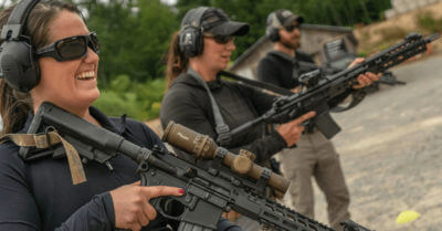 Military personnel holding long guns.