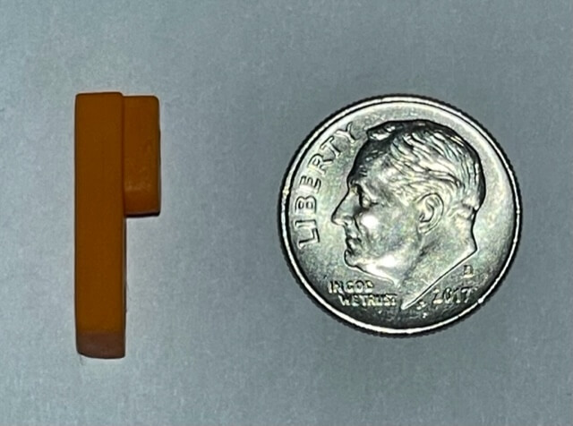 The Stacker shown next to a dime
