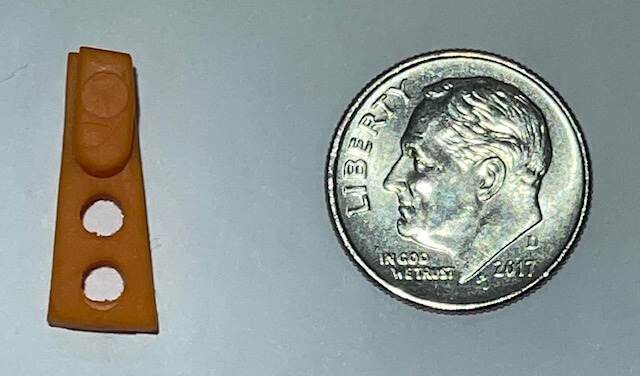 The Stacker shown next to a dime