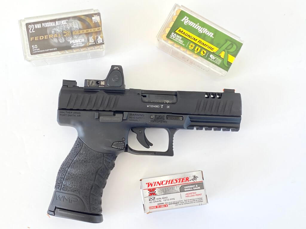 Walther WMP with boxes of 22 win mag ammo. 