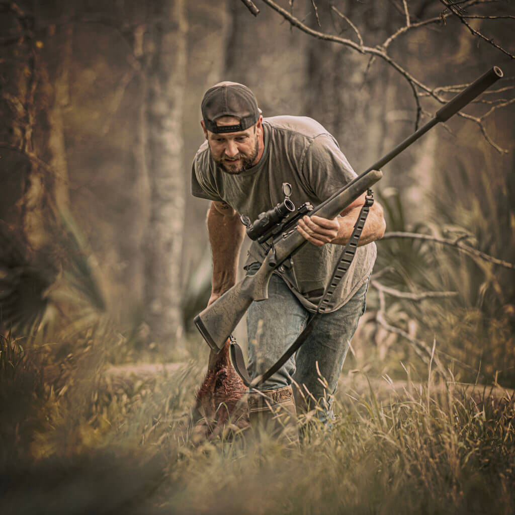 A hunter in the field with a Sightmark Wraith, a Mini Thermal Riflescope