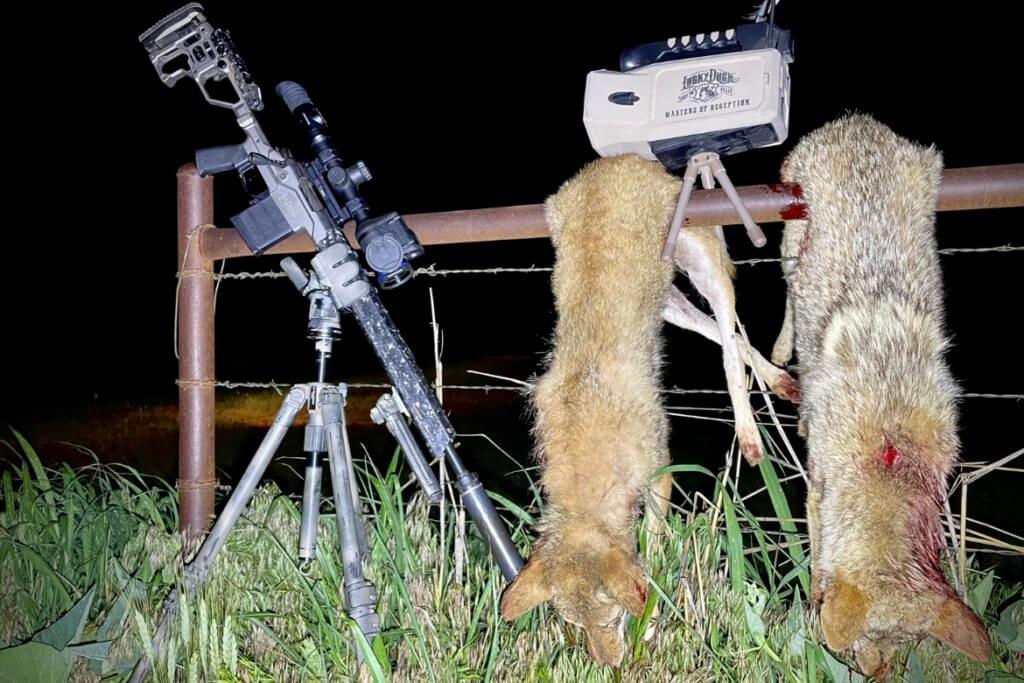 Christensen Arms MPR topped with a Pulsar Thermion 2 LRF XP50 Pro sitting in a Kopfjager K800 tripod next to a Lucky Duck Super Revolt call that was used to lure in two coyotes