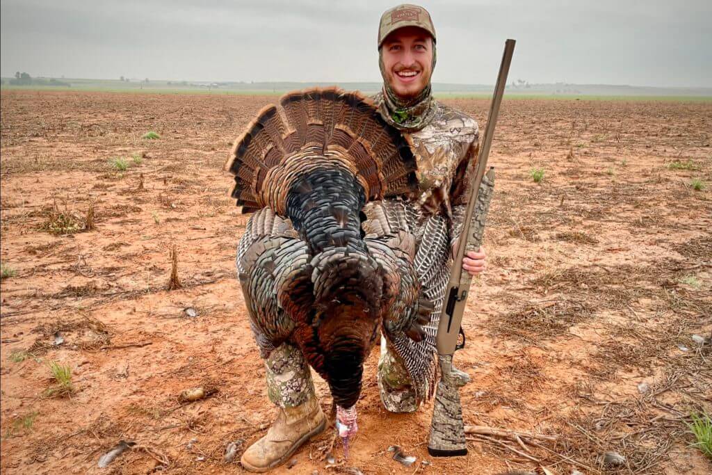 Hunter holding the Retay Masai Mara Cerakote after successfully shooting a turkey