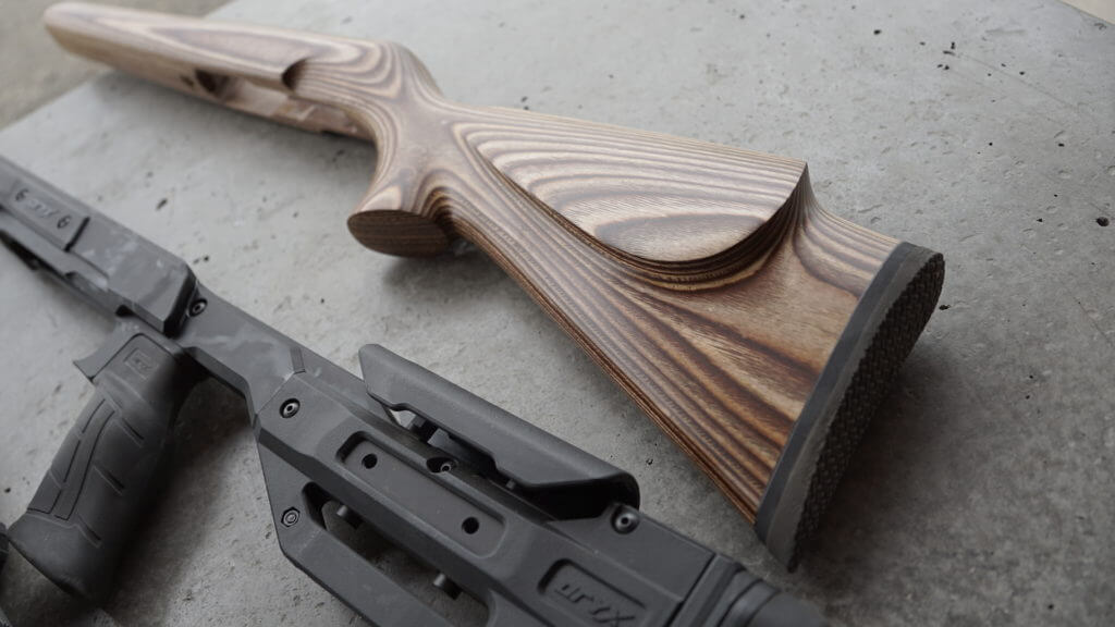 Beautiful Volquartsen wood stock next to carbon fiber stock