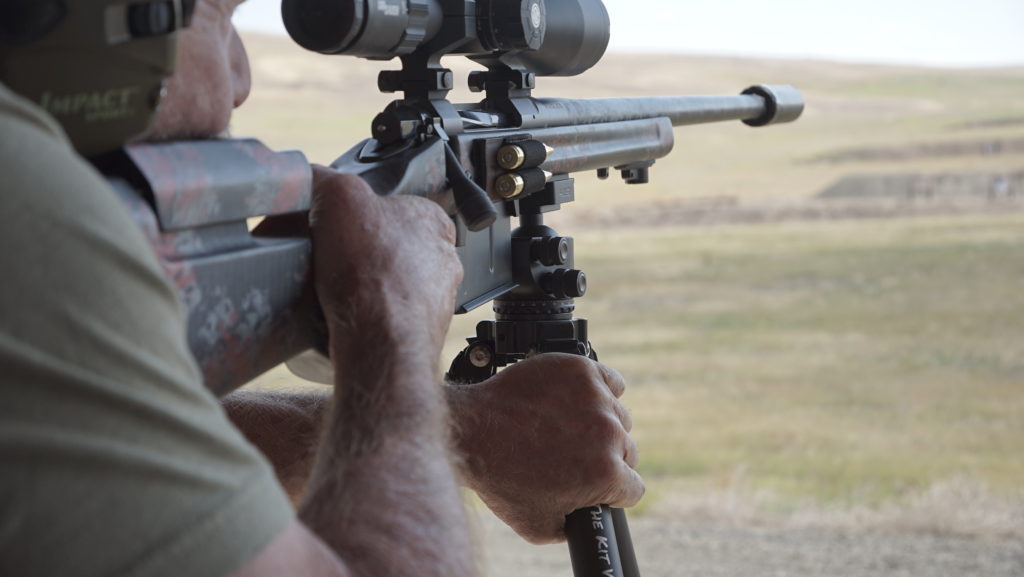 Hunter using a tripod to stabilize rifle