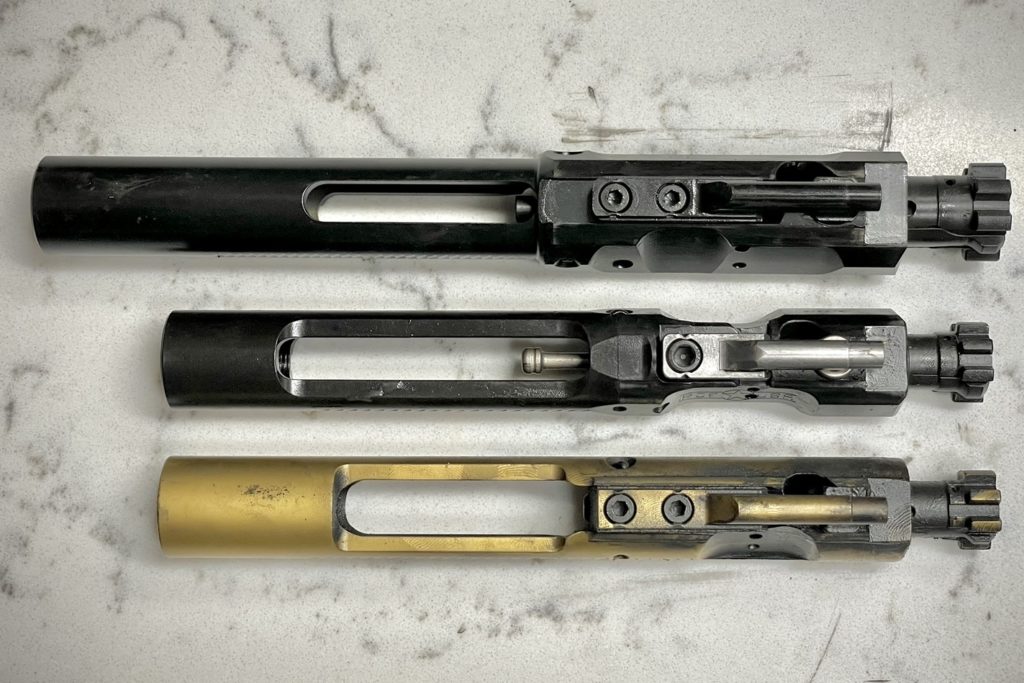 From top to bottom: standard AR10 BCG, POF Rogue BCG, standard AR15 BCG