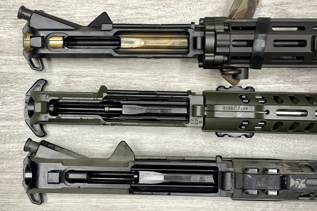 From top to bottom: standard AR15 upper, POF Rogue upper, standard DPMS AR10 upper