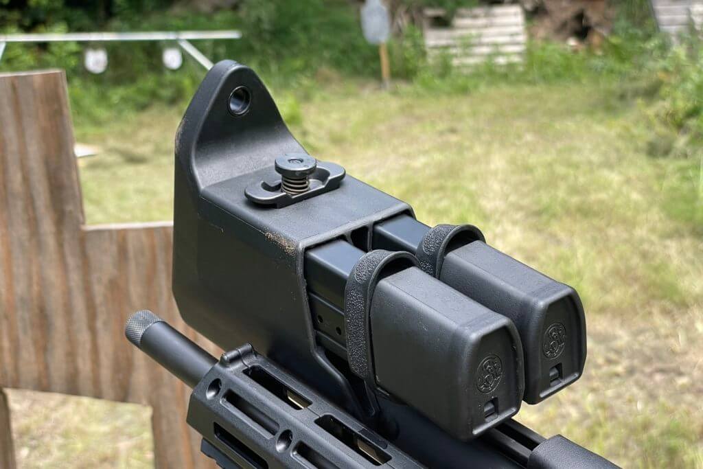 The double mag carrier integrated in the stock of the FPC with the quick release locking mechanism sticking up from the bottom