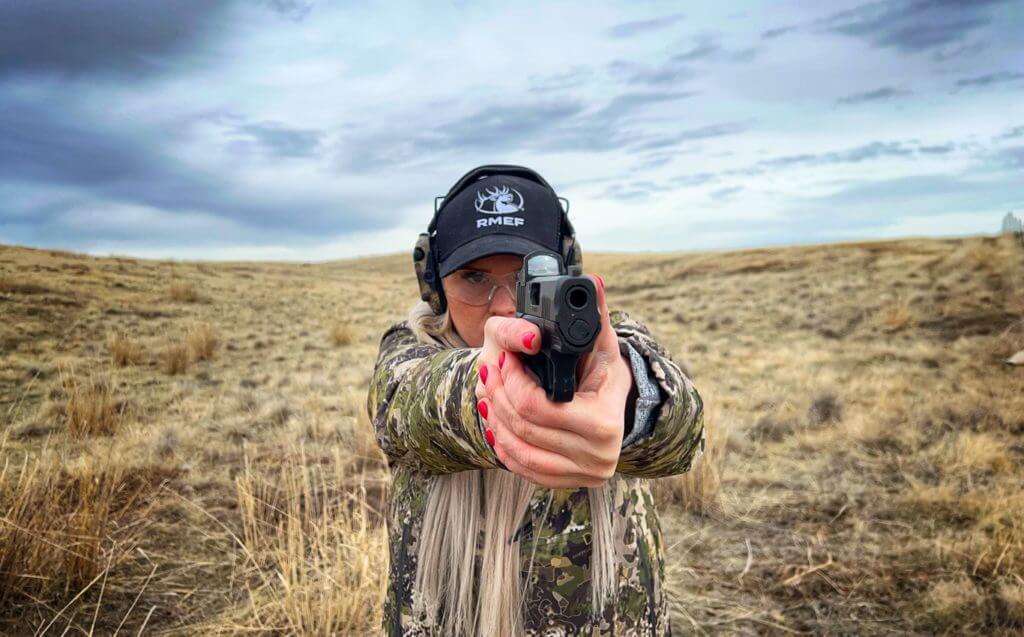 Shooter holding pistol preparing to shoot