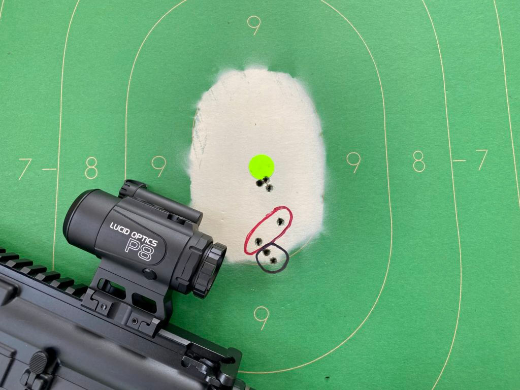 7 bullet holes in a cardboard target