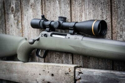 A picture of the Savage 110 Trail Hunter against a fence.