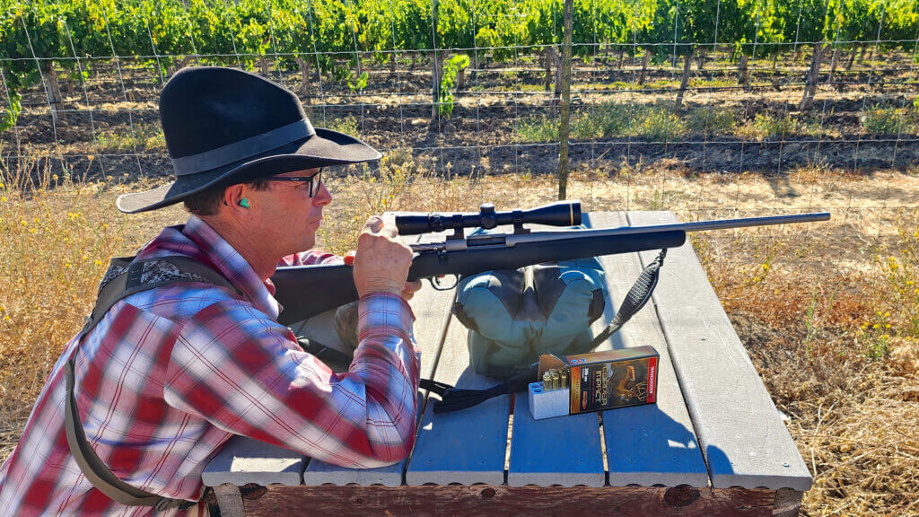 Shooter checking the zero on a rifle before shooting at the Steinbeck Vineyards