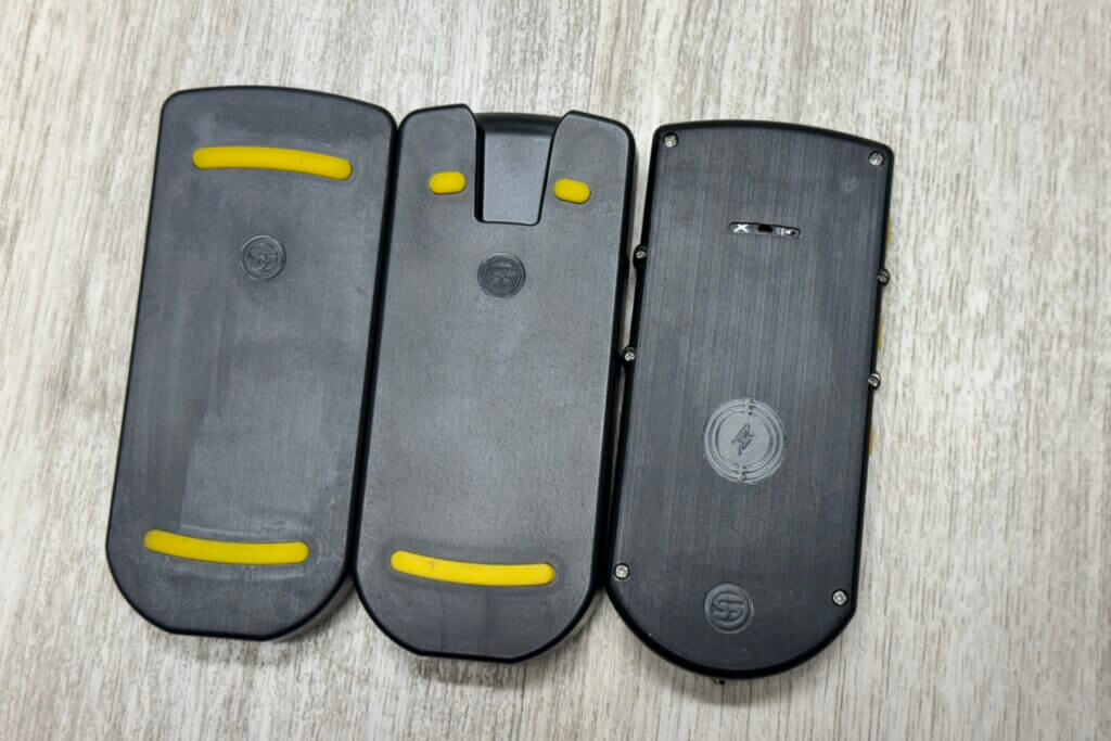 U-Grip holders. Left is the original, the middle one is what currently ships with the timers, and on the right is the timer itself with the buzzer microphone slit in the top middle. 