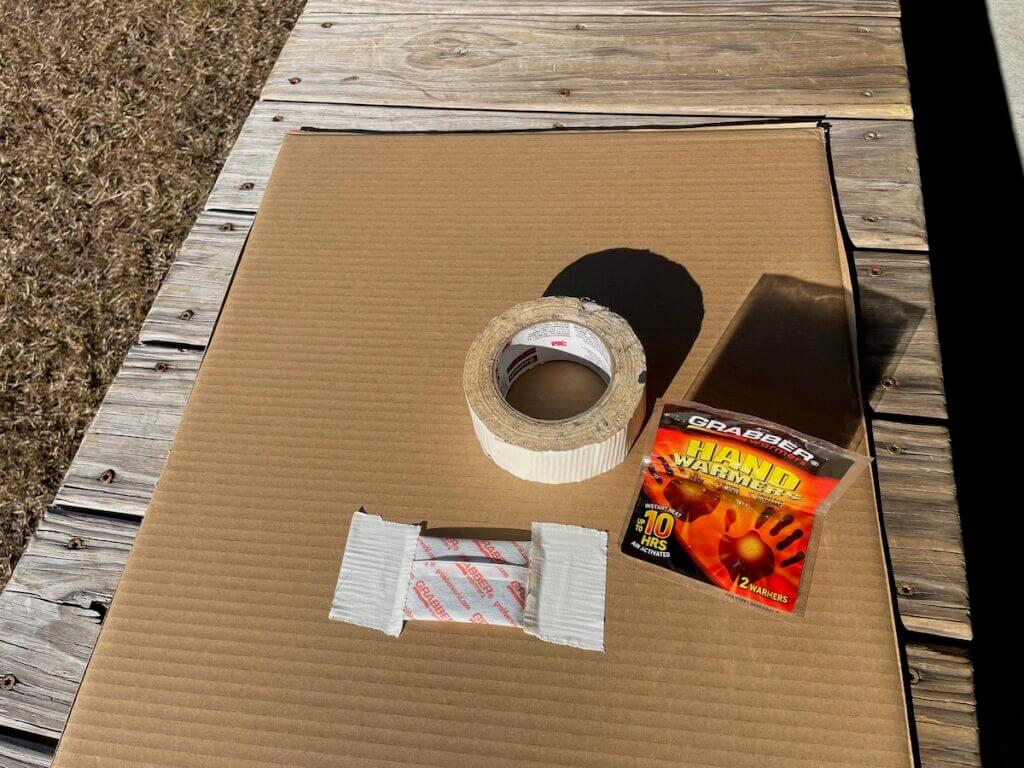 Cardboard with handwarmers and tape