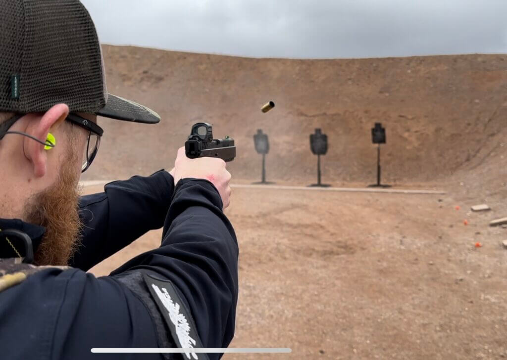 A man shoots the RIA 5.0 E at the gun range.