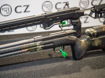 Close up view of the CZ 457s with the Manners stock and the MDT Chassis. The guns are facing left on a table.