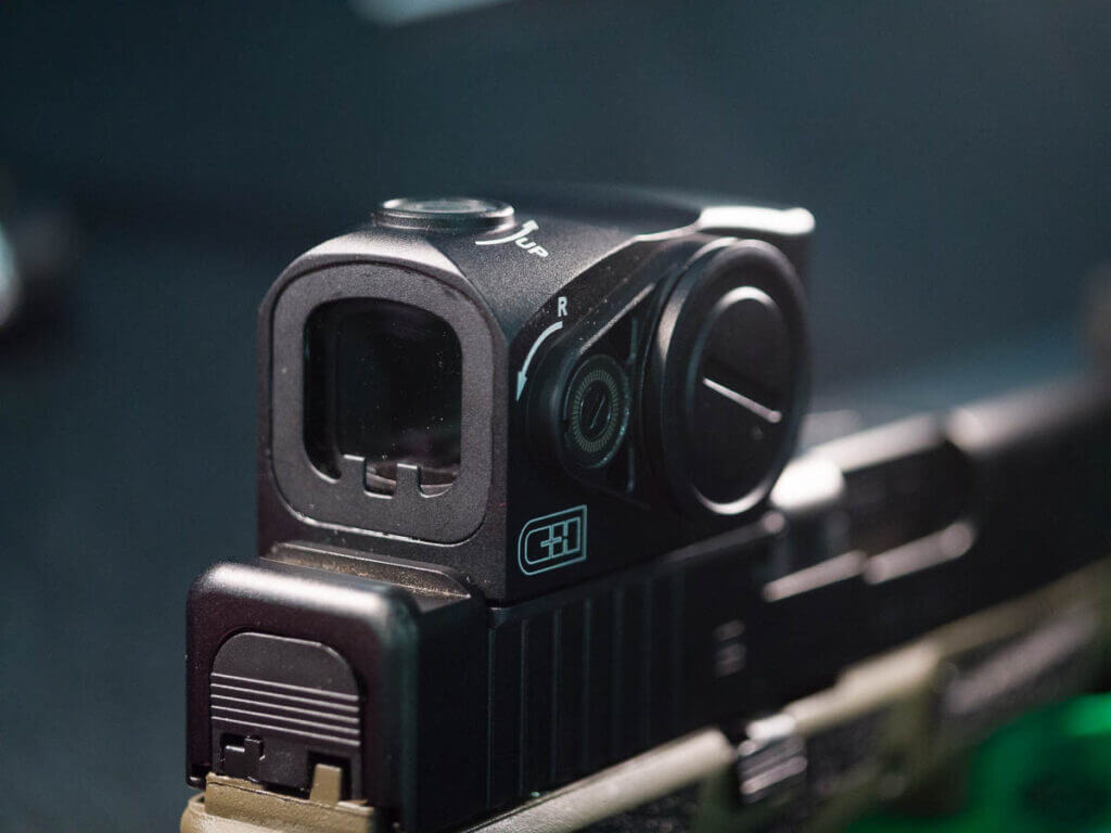 Close up view of the red dot on a pistol.
