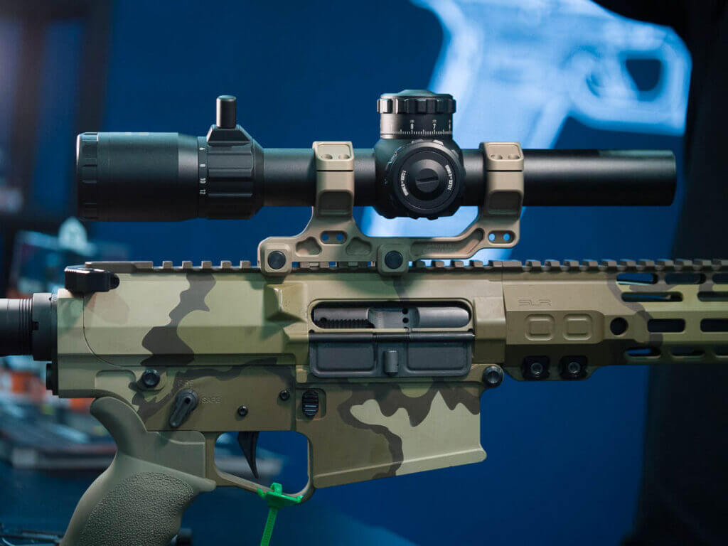 Close up of an AR with the full scope in profile view on top.