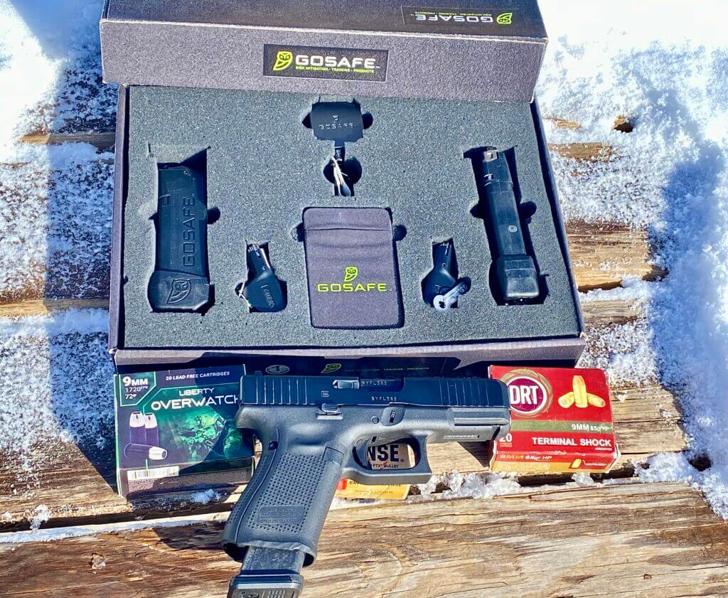 The GOSAFE Mobile Safe and Mobile mag in box with handgun and ammo on the table