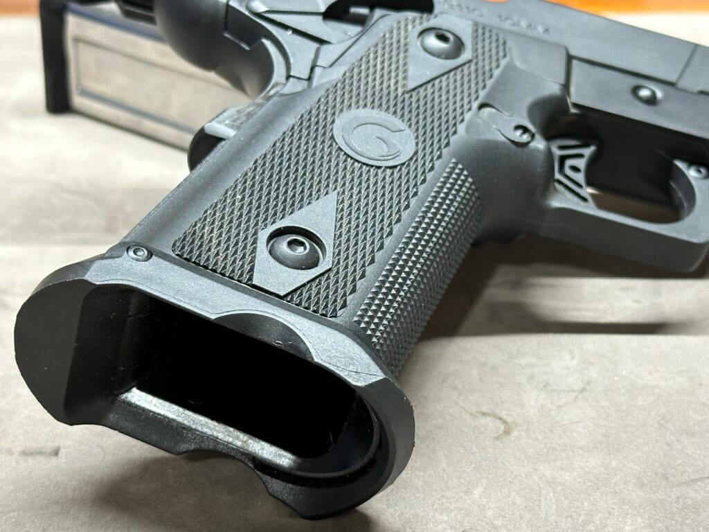 Closeup of the Girsan Witness2311 handgun's textured grip and magwell.