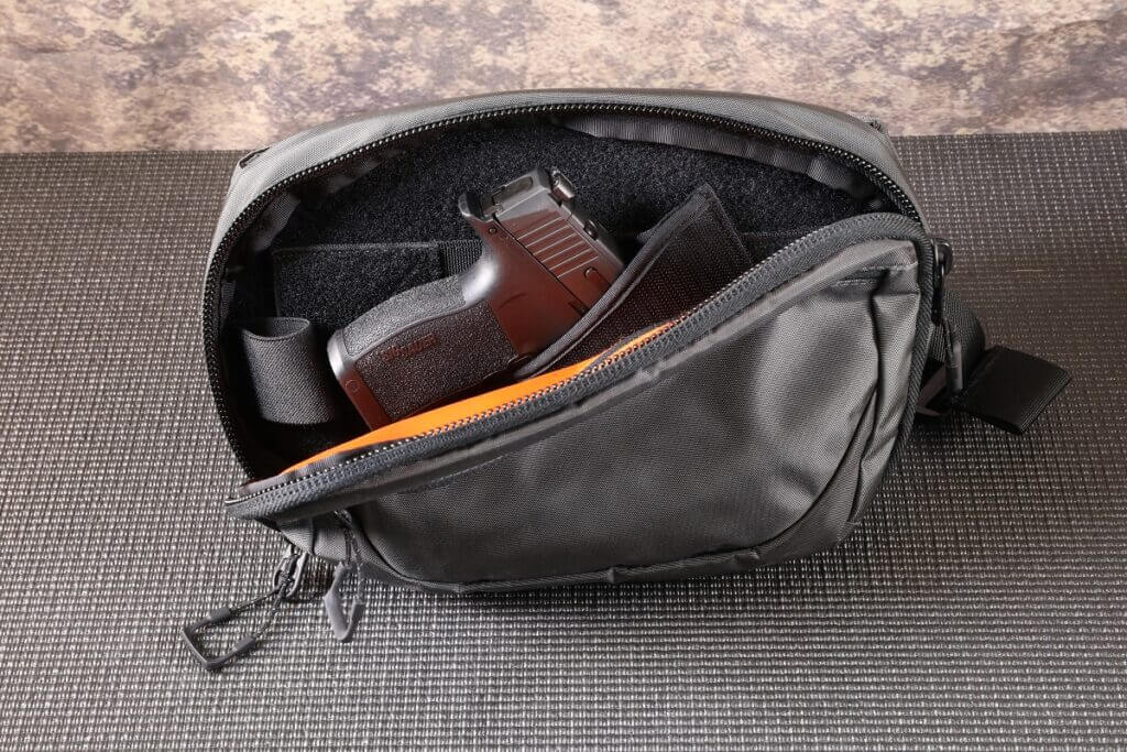 A black fanny pack with a handgun in it for Mother's Day