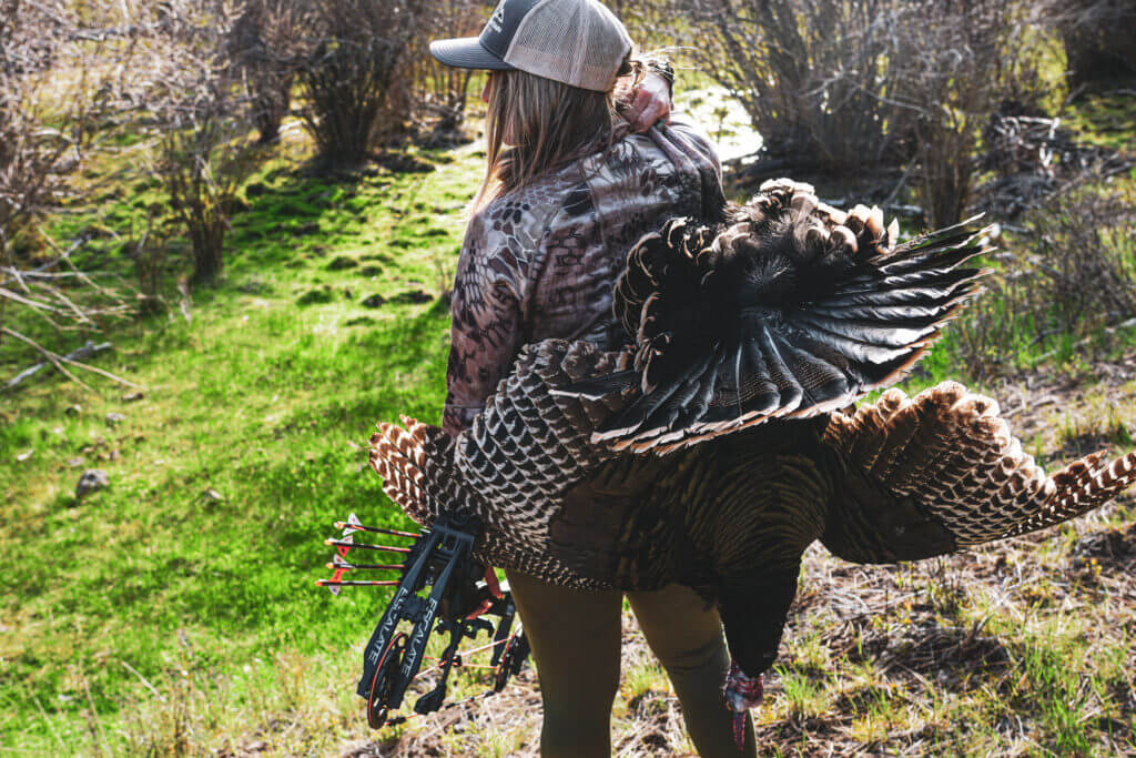 Female hunter coming home after turkey hunting