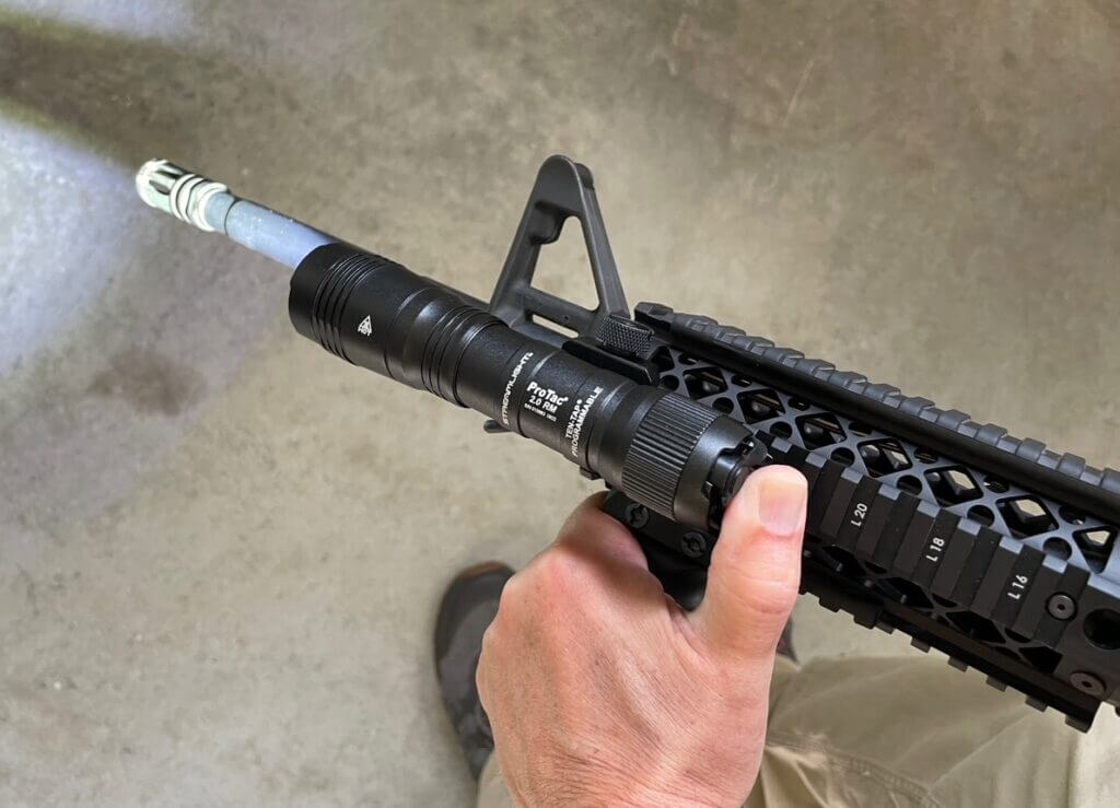 thumb activated tactical light on AR15 with a quad rail