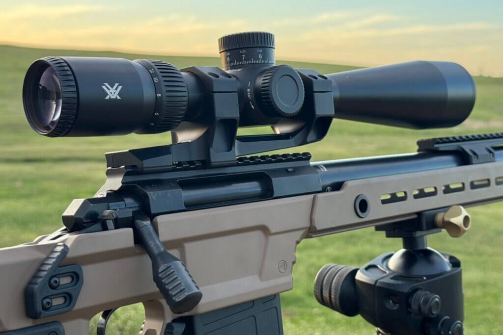 The Vortex Viper HD 5-25 scope set up on a rifle out in a bright green field