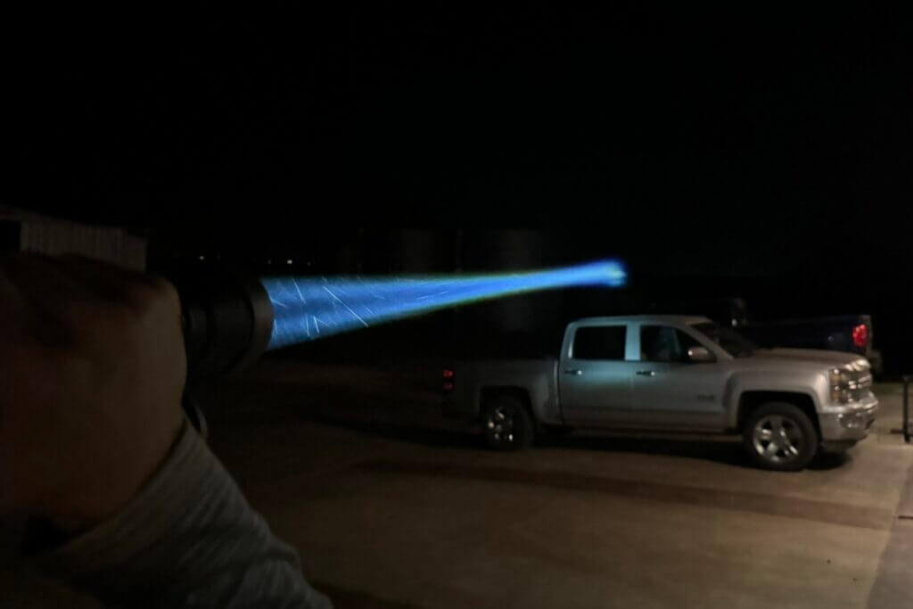 The beam of the W4Pro TAC from the back of a silver truck in the dark