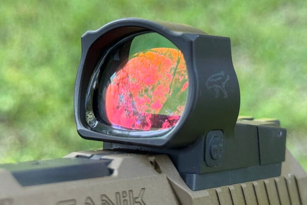 colorful reflection on the glass of a red dot