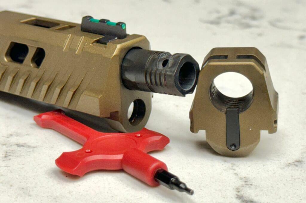 Spring-loaded tab on the compensator of a CANiK handgun