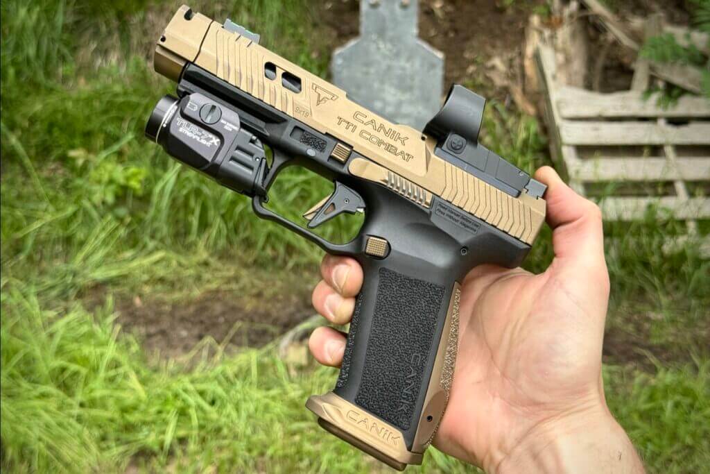 The CANIK TTI Combat tactical pistol outside getting ready to shoot