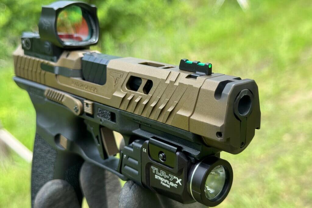 A look at the barrel of the CANiK TTI Combat pistol with a Streamlight TLR-7X light installed