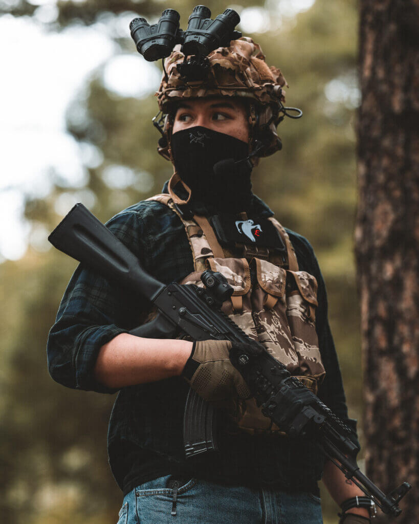 Shooter out in the forest with gun after mounting an optic