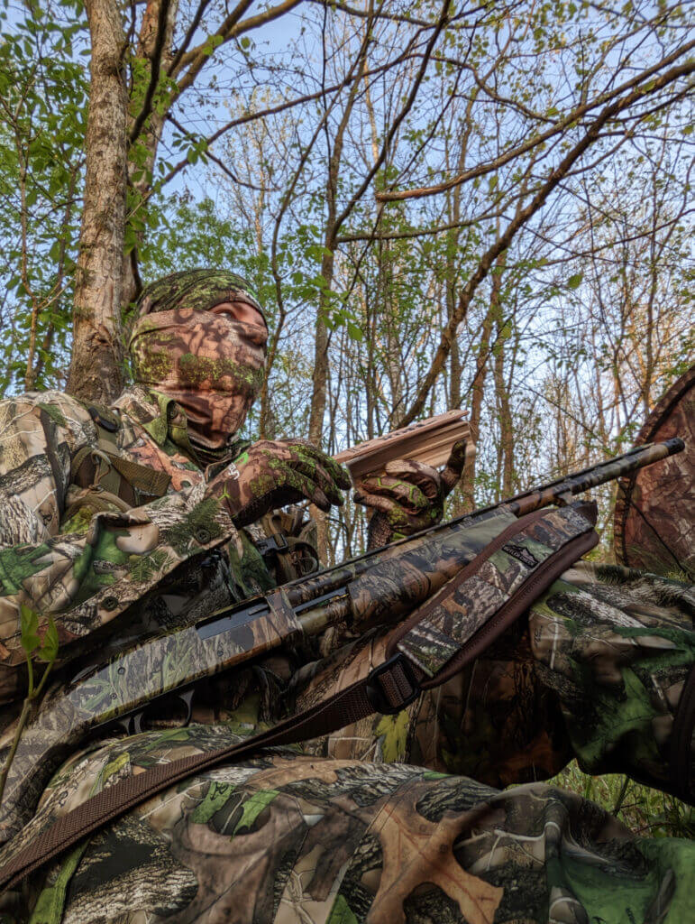 Hunter using a turkey box call and a 20 gauge Turkey shotgun