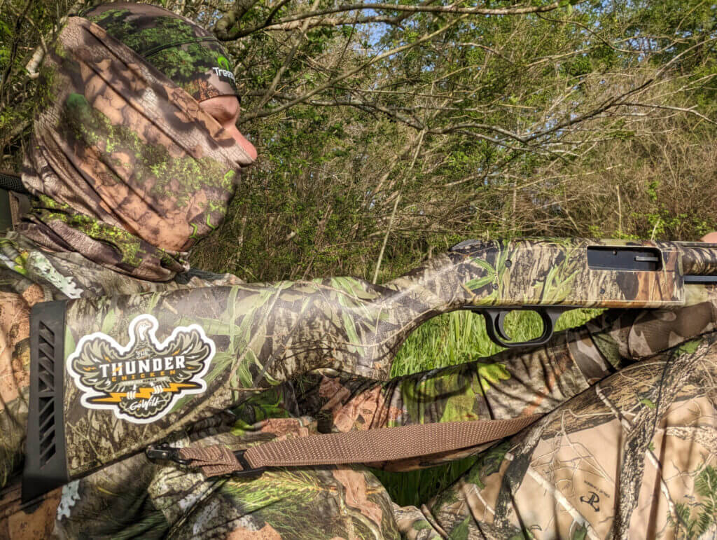 hunter in camo with mossberg 500 shotgun