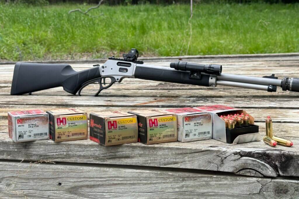 Smith & Wesson Model 1854 on a wooden table with six boxes of ammo