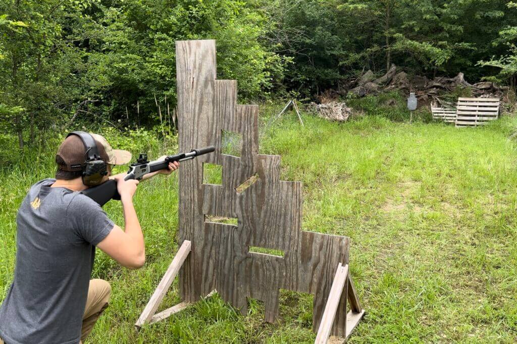 Shooter firing a Smith & Wesson lever-action rifle outside