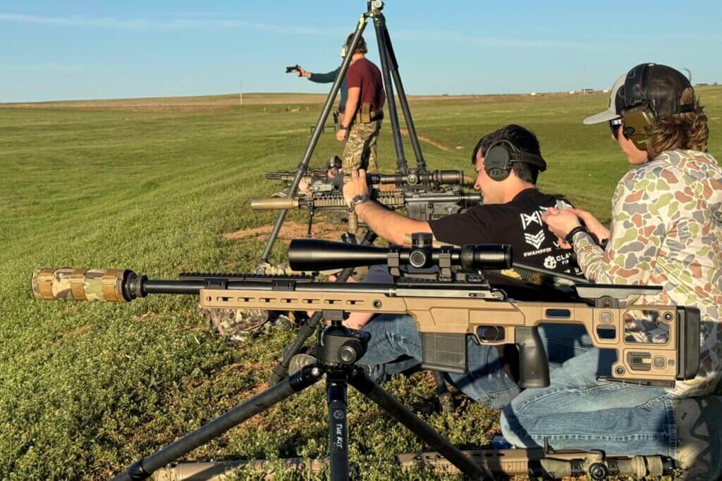 men shooting rifles at a range