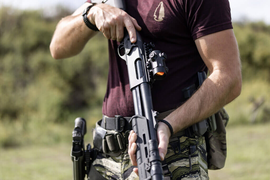 Shooter holding Remington 870